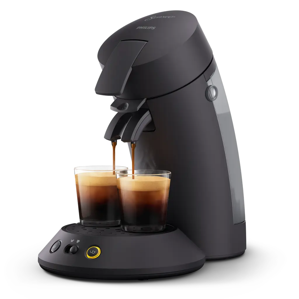 Matt-black Philips SENSEO Original Plus CSA210/60 with a black lever and an illustrative coffee cup under the spout; cup and coffee are usage examples