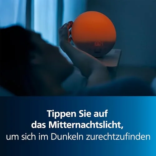 Philips-Werbeabbildung zur Mitternachtslicht-Funktion des HF3532/01 mit gedimmtem orangefarbenem Licht und einer Hand am Gerät