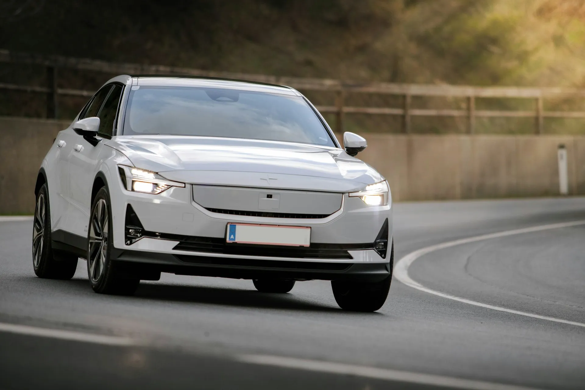 White car on a winding road